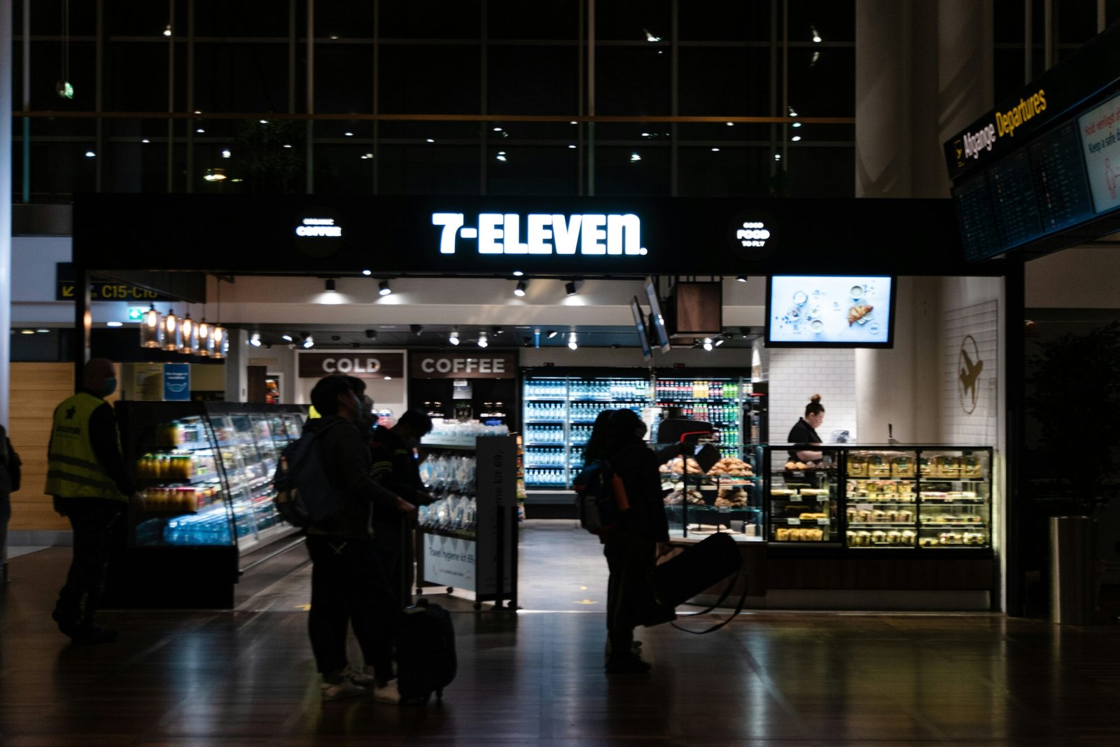 a group of people standing in front of a store